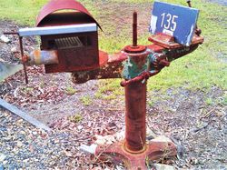 Old machinery parts make long lasting mailbox stands - photo by Vivienne Tracy